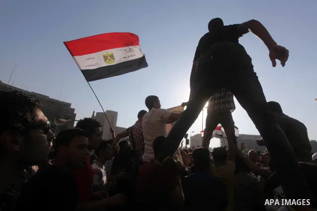 Protesters wave Egypt's flags during a demonstration at Tahrir square in Cairo, against the verdict for deposed leader Hosni Mubarak June 4, 2012. Egyptian pro-democracy campaigners called on Sunday for a new uprising, s...