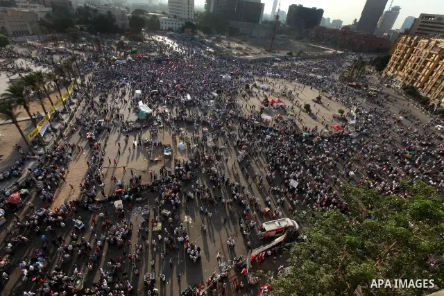 Egyptian protesters wave national flags during a demonstration in Cairo's landmark Tahrir Square on June 5, 2012 to protest against verdicts handed down in ex-president Hosni Mubarak's murder trial. Mubarak and his inter...