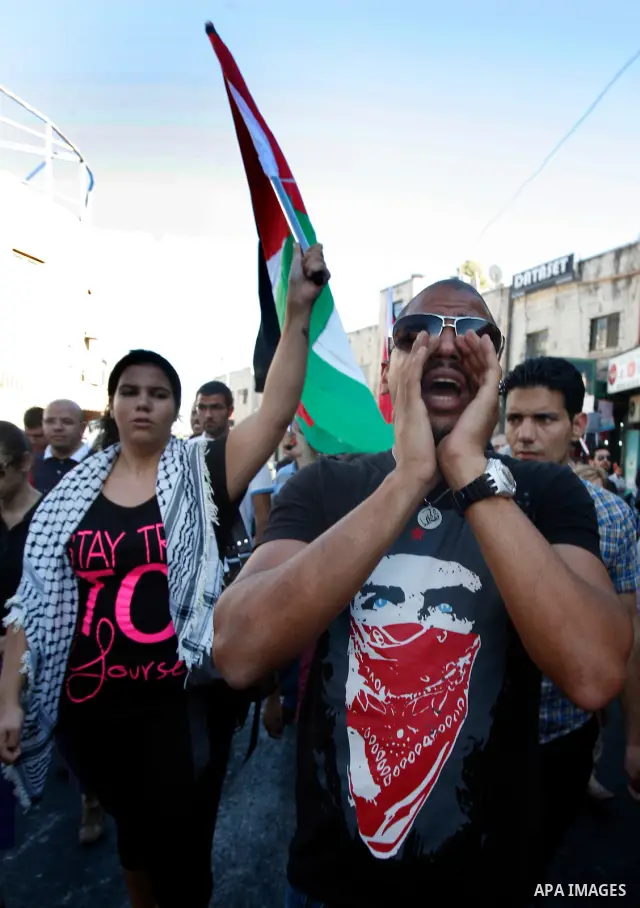 Palestinian protesters hold flags during a demonstration marking the 'Naksa Day' at the Damascus Gate on 05 June 2012. Naksa Day is the annual day of commemoration for the Palestinian people of the displacement that acco...