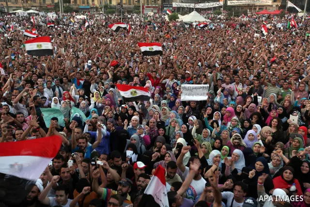 Egyptian protesters wave national flags during a demonstration in Cairo's landmark Tahrir Square on June 5, 2012 to protest against verdicts handed down in ex-president Hosni Mubarak's murder trial. Mubarak and his inter...