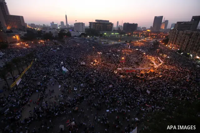 Egyptian protesters wave national flags during a demonstration in Cairo's landmark Tahrir Square on June 5, 2012 to protest against verdicts handed down in ex-president Hosni Mubarak's murder trial. Mubarak and his inter...
