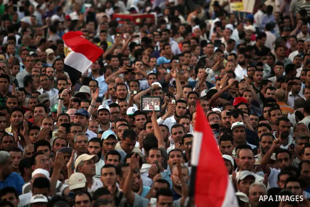 Egyptian protesters wave national flags during a demonstration in Cairo's landmark Tahrir Square on June 5, 2012 to protest against verdicts handed down in ex-president Hosni Mubarak's murder trial. Mubarak and his inter...