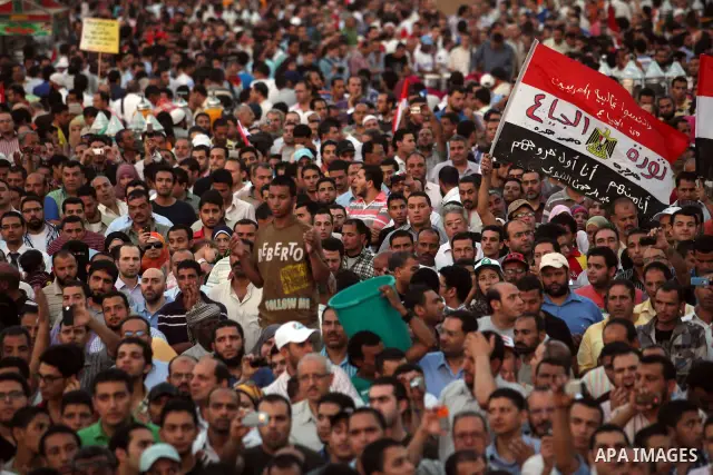Egyptian protesters wave national flags during a demonstration in Cairo's landmark Tahrir Square on June 5, 2012 to protest against verdicts handed down in ex-president Hosni Mubarak's murder trial. Mubarak and his inter...