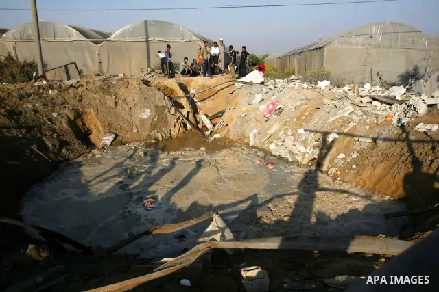 Palestinians inspect the damage at a chicken farm in in the southern Gaza Strip town of Rafah on June 5, 2012 following an Israeli air strike on the Gaza Strip. Photo by Eyad Al Baba