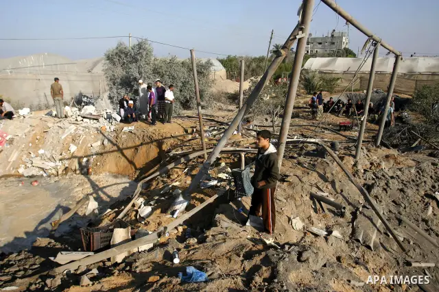 Palestinians inspect the damage at a chicken farm in in the southern Gaza Strip town of Rafah on June 5, 2012 following an Israeli air strike on the Gaza Strip. Photo by Eyad Al Baba