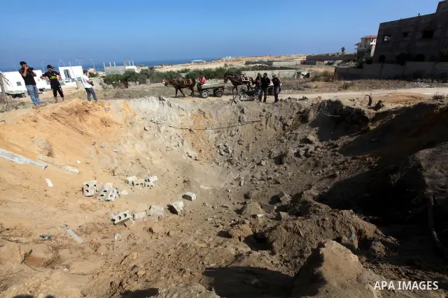 Palestinians inspect the damage at agricultural land in Al Sudania area in the northern Gaza Strip on June 6, 2012 following an Israeli air strike on the Gaza Strip. Photo by Ashraf Amra