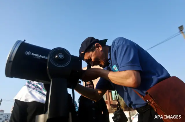 Palestinians look through a telescopes during the transit of planet Venus across the sun face during a rare celestial event in the Gaza Strip, 06 June 2012. Astronomy enthusiasts all over the world looked to the skies to...