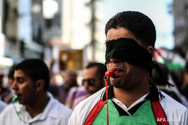 Palestinians shout slogans during a rally solidarity with Palestinian prisoner Mahmoud Al-Sarsak who is still refusing food after a deal was made to end a mass prisoner hunger strike, in the West Bank city of Ramallah on...