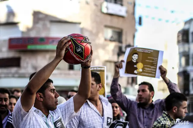 Palestinian youth play football in the streets of Ramallah during a rally solidarity with Palestinian prisoner Mahmoud Al-Sarsak who is still refusing food after a deal was made to end a mass prisoner hunger strike, on 0...