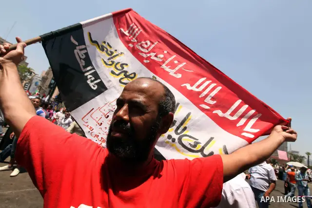 Egyptian protesters wave national flags during a demonstration against presidential candidate Ahmed Shafiq in central Cairo's Tahrir Square, as hundreds of people gathered after the Friday noon prayer on June 8, 2012 in...