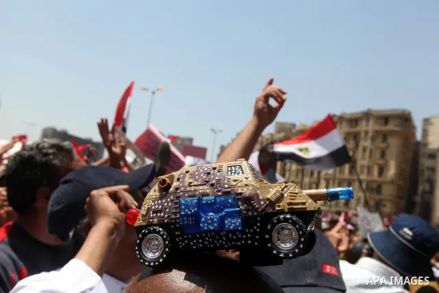 Egyptian protesters wave national flags during a demonstration against presidential candidate Ahmed Shafiq in central Cairo's Tahrir Square, as hundreds of people gathered after the Friday noon prayer on June 8, 2012 in...