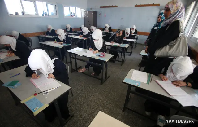 Palestinian Prime Minister in Gaza Strip, Ismail Haniya, (not seen) visits students as they sit for their final high school exams, known as "Tawjihi", in Gaza City on June 09, 2012. Photo by Yasser Fathi