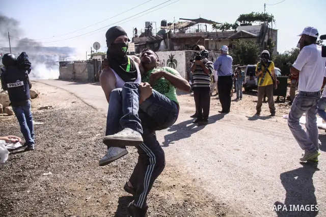 Palestinian demonstrators and Israeli forces clash after a protest by Palestinians calling for the return of displaced Palestinians to their villages occupied by Israel in 1967, in the West Bank village of Beit Nuba, nea...