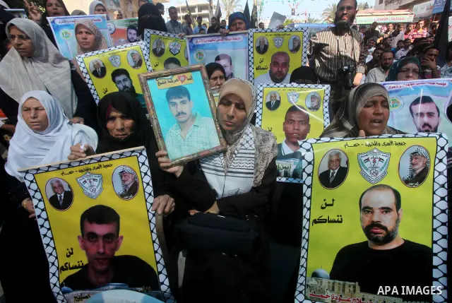 Palestinians gather during a protest at the Red Cross' offices in Gaza City to call for the release of Palestinian prisoners held in Israeli jails, on June 11, 2012. Al-Sarsak and al-Rekhawi are on hunger strike to prote...