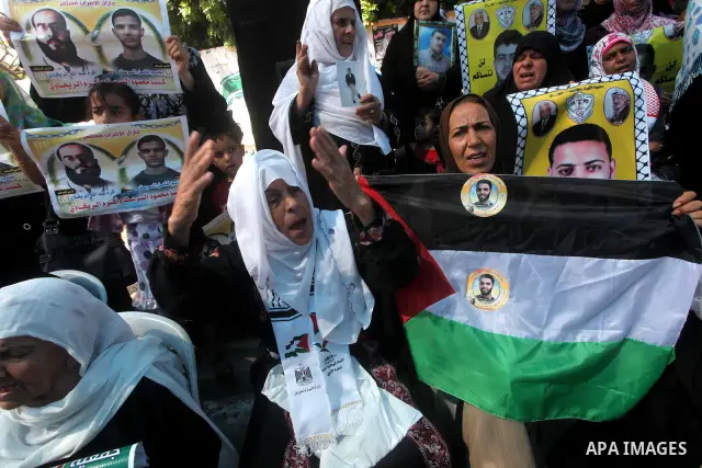 Palestinians gather during a protest at the Red Cross' offices in Gaza City to call for the release of Palestinian prisoners held in Israeli jails, on June 11, 2012. Al-Sarsak and al-Rekhawi are on hunger strike to prote...