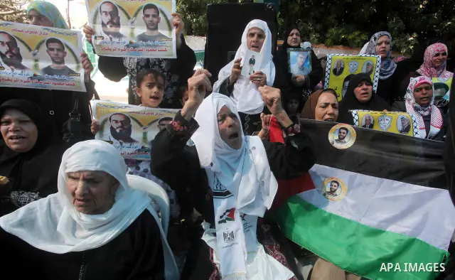 Palestinians gather during a protest at the Red Cross' offices in Gaza City to call for the release of Palestinian prisoners held in Israeli jails, on June 11, 2012. Al-Sarsak and al-Rekhawi are on hunger strike to prote...