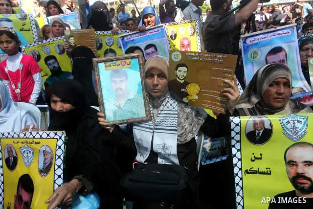 Palestinians gather during a protest at the Red Cross' offices in Gaza City to call for the release of Palestinian prisoners held in Israeli jails, on June 11, 2012. Al-Sarsak and al-Rekhawi are on hunger strike to prote...