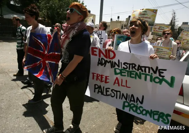 Palestinians and Foreigners hold posters depicting prisoners Mahmoud Al-Sarsak, and Akram al-Rekhawi during a rally in solidarity with them in the red cross offices in jerusalem city, on June 11, 2012. Photo by Mahfouz A...