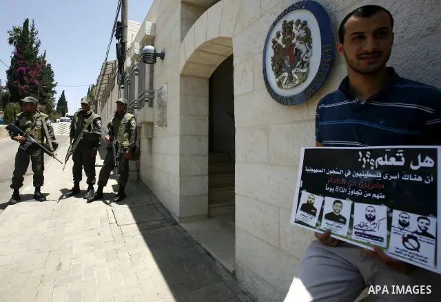 Palestinians and Foreigners hold posters depicting prisoners Mahmoud Al-Sarsak, and Akram al-Rekhawi during a rally in solidarity with them in the red cross offices in jerusalem city, on June 11, 2012. Photo by Mahfouz A...