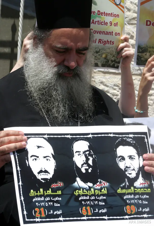 Palestinians and Foreigners hold posters depicting prisoners Mahmoud Al-Sarsak, and Akram al-Rekhawi during a rally in solidarity with them in the red cross offices in jerusalem city, on June 11, 2012. Photo by Mahfouz A...