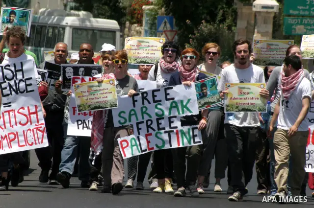 Palestinians and Foreigners hold posters depicting prisoners Mahmoud Al-Sarsak, and Akram al-Rekhawi during a rally in solidarity with them in the red cross offices in jerusalem city, on June 11, 2012. Photo by Mahfouz A...
