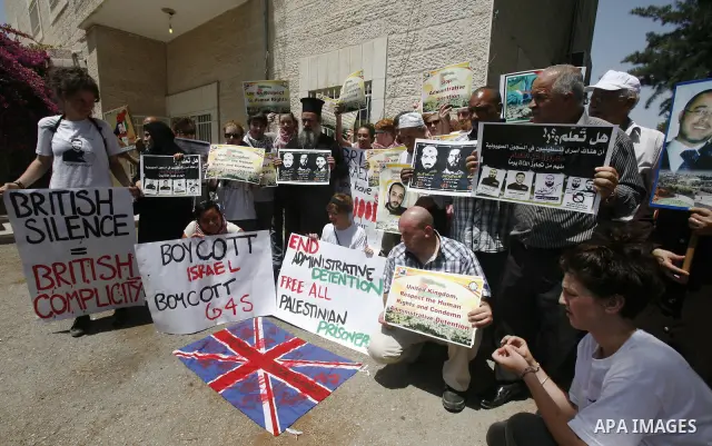 Palestinians and Foreigners hold posters depicting prisoners Mahmoud Al-Sarsak, and Akram al-Rekhawi during a rally in solidarity with them in the red cross offices in jerusalem city, on June 11, 2012. Photo by Mahfouz A...