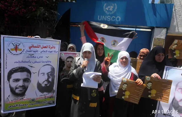 Palestinian women hold pictures of Palestinian prisoners Mahmoud Al-Sarsak and Akram Al-Rikhawi, whose are still refusing food for 86 days after a deal was made to end a mass prisoner hunger strike, during a demonstratio...