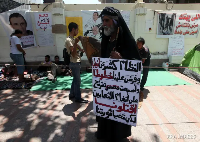 Protesters sit on the floor during a hunger strike in front of Egypt's cabinet office in Cairo on June 12, 2012. Around 60 activists are on the sixth day of a hunger strike demanding that former military man Ahmed Shafik...