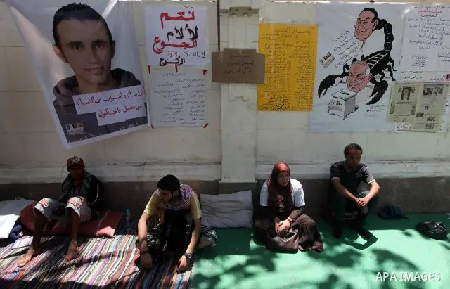 Protesters sit on the floor during a hunger strike in front of Egypt's cabinet office in Cairo on June 12, 2012. Around 60 activists are on the sixth day of a hunger strike demanding that former military man Ahmed Shafik...