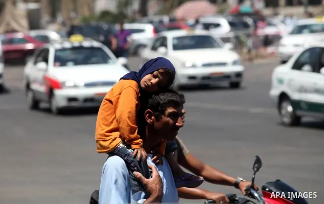 Egyptians rides motorcyclein front of a defaced campaign election banners of presidential candidate and former prime minister Ahmed Shafik in Cairo June 12, 2012. The run-off on June 16 and 17 is the last stage in Egypt'...