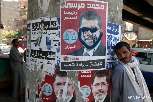 Campaign posters of former Hosni Mubarak's last Muslim Brotherhood candidate Mohammed Mursi are seen hanging in Cairo's al-Sayeda Zenab district on June 12, 2012. A few days before the second round of the historical elec...