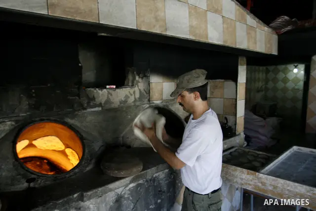 A Palestinian baker prepares bread at his bakery in Rafah, southern Gaza Strip on June 13, 2012. The European Union's envoy to the Palestinian Authority confirmed its support and allegiance to the people. Photo by Eyad A...