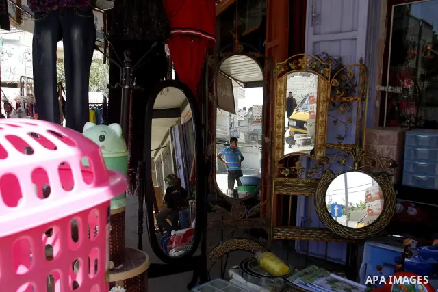 A Palestinian man stands in his shop at market Rafah, southern Gaza city, on June 13, 2012. The European Union's envoy to the Palestinian Authority confirmed its support and allegiance to the people. Photo by Eyad Al Bab...