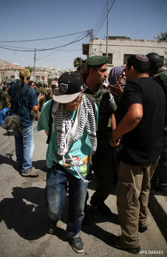 Israeli soldiers and border police try to arrest a demonstrator during a demonstration on al-Shuhada street against the closure of the central street in the West Bank town of Hebron, on June 13, 2012. The street is close...