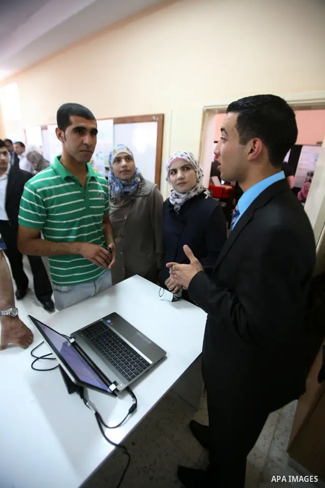 Palestinian students participate in the exhibition of "Creativity of the student" at the Palestine Polytechnic University in the West Bank city of Hebron on 13 June 2012. Photo by Mamoun Wazwaz