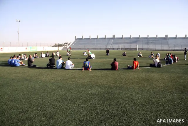 Palestinian athletes hold pictures and banners for prisoner Mahmoud Sarsak, a former player with the Palestinian national football team held in Israeli jails, during a protest calling for release him, at Al-Bireh playgro...