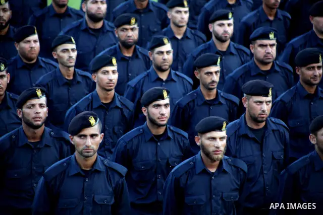 Graduating police officers stand to attention during a ceremony at the police academy in Gaza City on June 13, 2012, making them the first batch of officers to graduate after four years of training under the Hamas leader...