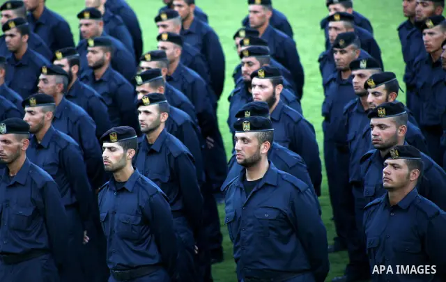 Graduating police officers stand to attention during a ceremony at the police academy in Gaza City on June 13, 2012, making them the first batch of officers to graduate after four years of training under the Hamas leader...
