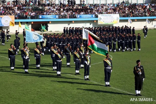 Graduating police officers stand to attention during a ceremony at the police academy in Gaza City on June 13, 2012, making them the first batch of officers to graduate after four years of training under the Hamas leader...