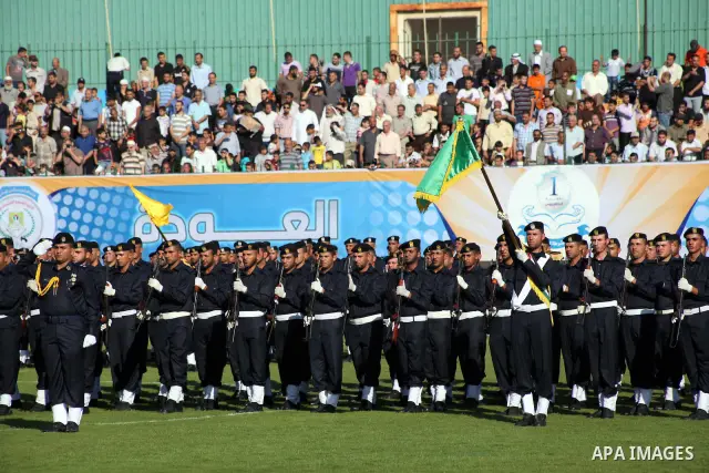 Graduating police officers stand to attention during a ceremony at the police academy in Gaza City on June 13, 2012, making them the first batch of officers to graduate after four years of training under the Hamas leader...