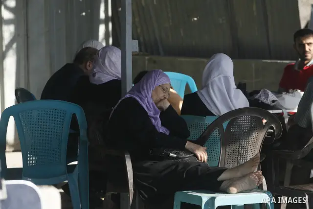 Palestinians load their luggage as they wait to cross into Egypt through the Rafah border crossing in the southern Gaza Strip on June 13, 2013. After the stopping of the Rafah border crossing from the Egyptian side Becau...