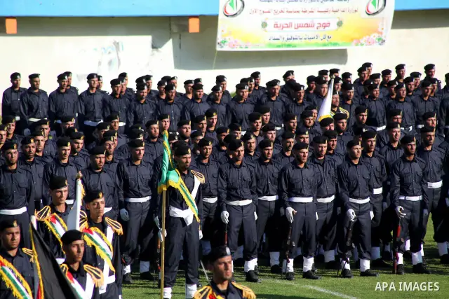 Graduating police officers stand to attention during a ceremony at the police academy in Gaza City on June 13, 2012, making them the first batch of officers to graduate after four years of training under the Hamas leader...