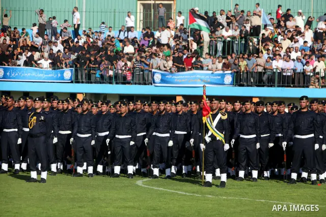 Graduating police officers stand to attention during a ceremony at the police academy in Gaza City on June 13, 2012, making them the first batch of officers to graduate after four years of training under the Hamas leader...