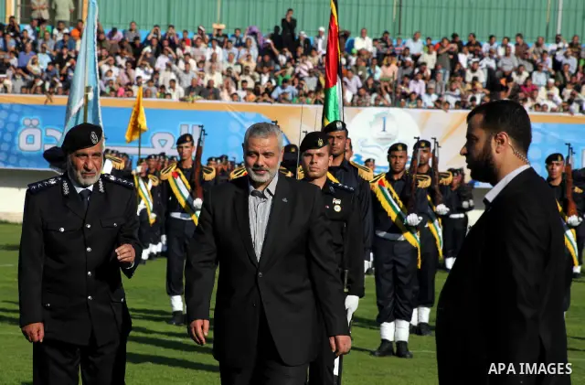 Palestinian Prime Minister in Gaza Ismail Hanyeh, participates graduation police officers ceremony at the police academy in Gaza City on June 13, 2012, making them the first batch of officers to graduate after four years...