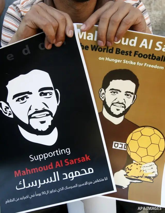 Palestinians hold posters depicting footballer Mahmoud Al-Sarsak, who is protesting his alleged illegal detention by Israel, during a rally in the old city of Jerusalem on June 13, 2012. FIFA president Sepp Blatter has e...