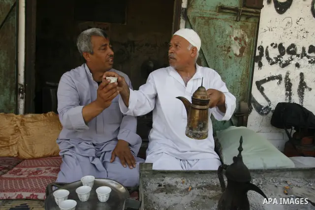 Palestinians drink the coffee near the home in Rafah refugee camp, southern Gaza city, on June 14, 2012. Photo by Eyad Al Baba