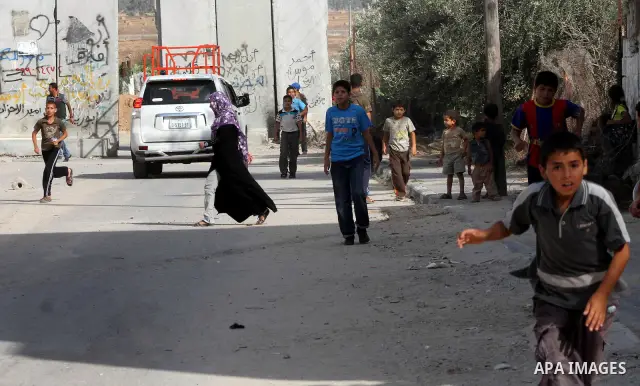 Palestinians gather near Khuza'a town , in the east of Khan Younis city in the south of gaza strip during raids of Israeli helicopters and tanks on 14 June 2012. Palestinian medical sources confirmed the presence of inju...