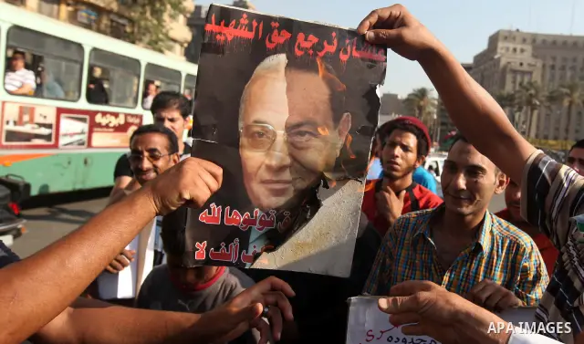 Egyptian protesters burn a placard against presidential candidate Ahmed Shafik during a protest at Cairo's Tahrir square, Egypt, 14 June 2012. Media reports on 14 June state that the Supreme Constitutional Court ruled th...