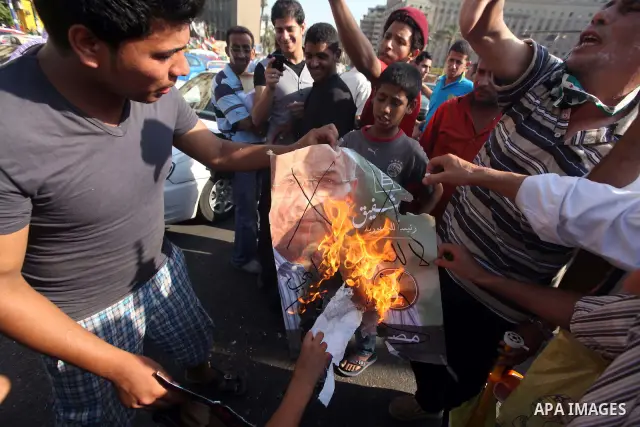 Egyptian protesters burn a placard against presidential candidate Ahmed Shafik during a protest at Cairo's Tahrir square, Egypt, 14 June 2012. Media reports on 14 June state that the Supreme Constitutional Court ruled th...