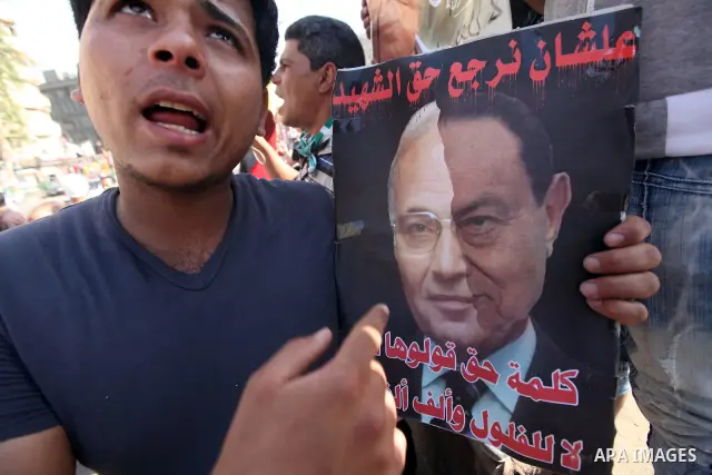 An Egyptian protester holds a placard against presidential candidate Ahmed Shafik during a protest at Cairo's Tahrir square, Egypt, 14 June 2012. Media reports on 14 June state that the Supreme Constitutional Court ruled...